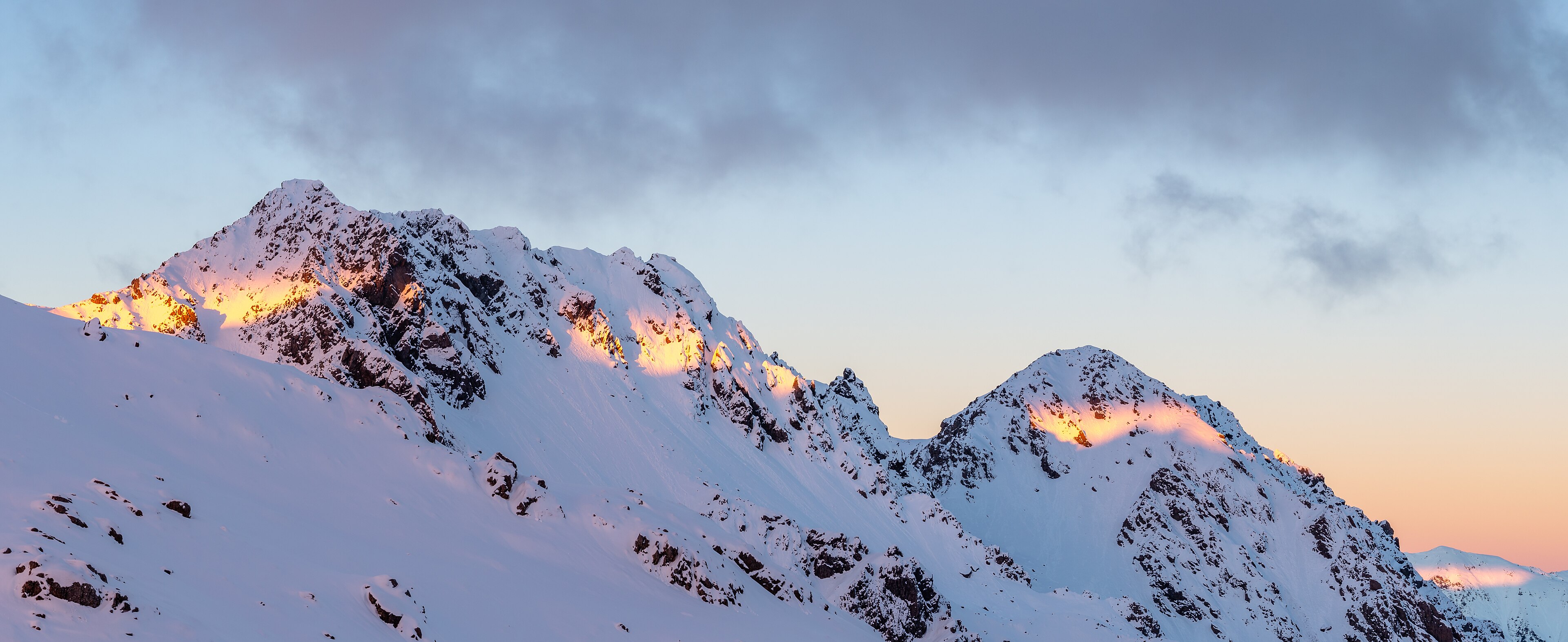 Last light hitting snow-covered peaks in Nelson Lakes National Park
